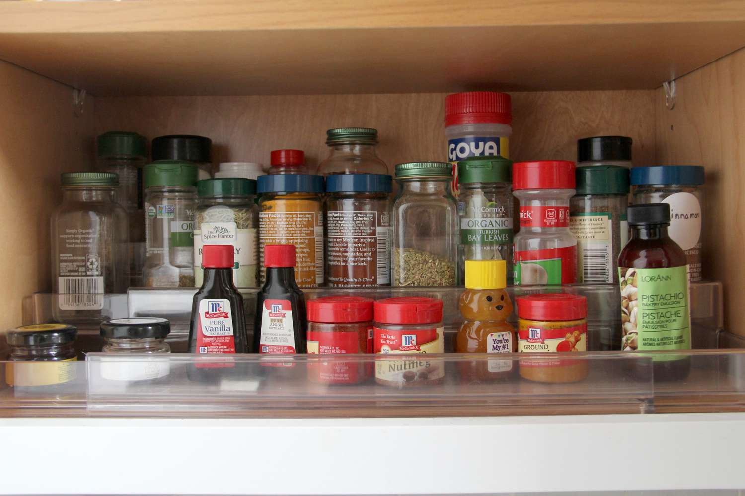 a spice rack with a variety of spices and aromatics lined up on it