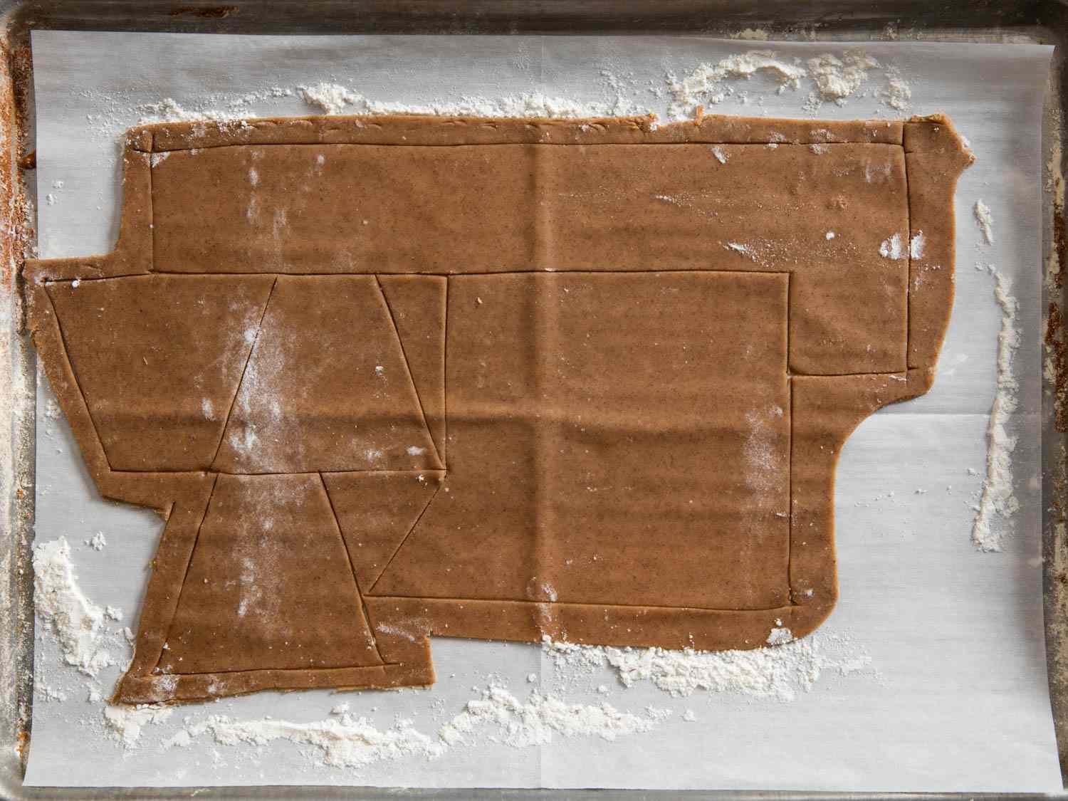 More shapes cut into the construction ginger bread in a pan.