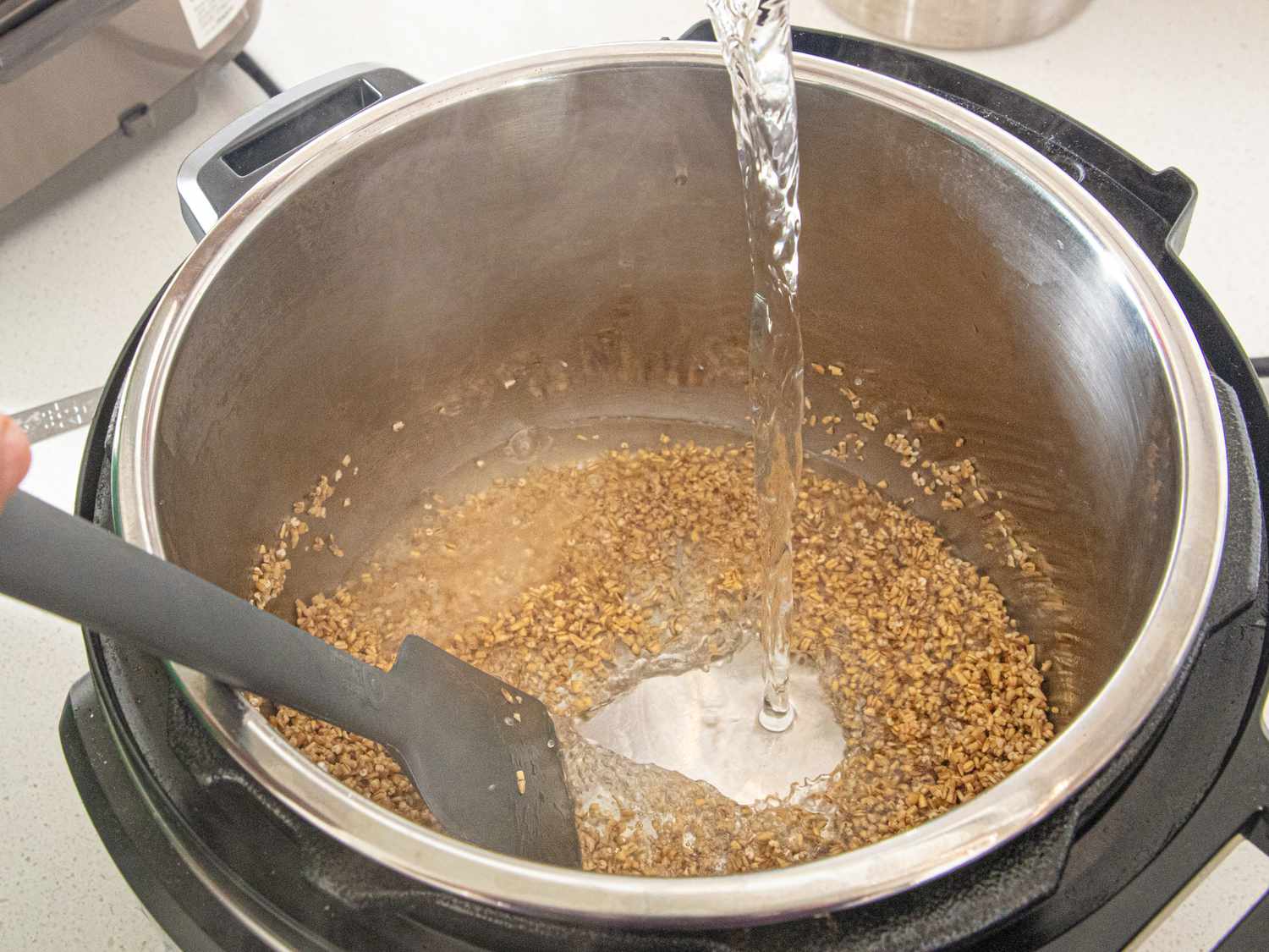 Overhead view of pouring water into the oats