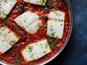 Closeup overhead of a skillet of baccalÃ  alla napoletana.