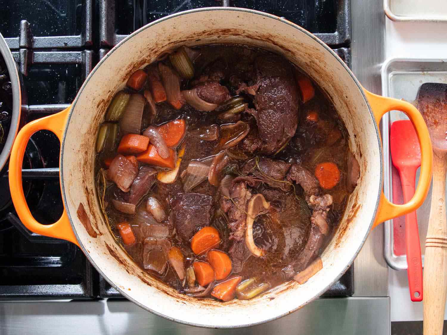 Stock is added and the contents are simmered and reduced.