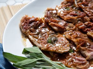 Veal saltimbocca in pan sauce, garnished with fresh sage