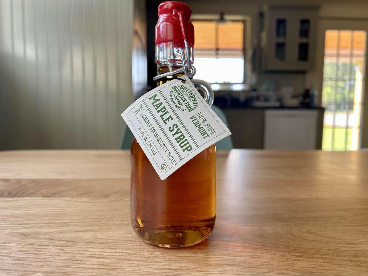 A bottle of Butternut Mountain Farm maple syrup on a kitchen table