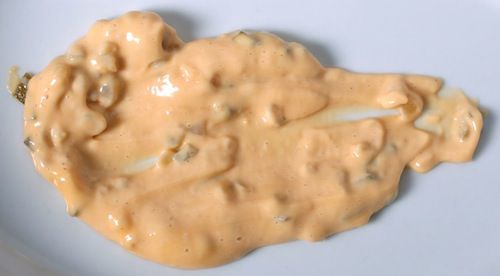 Closeup of Big Mac sauce smeared on a white plate.