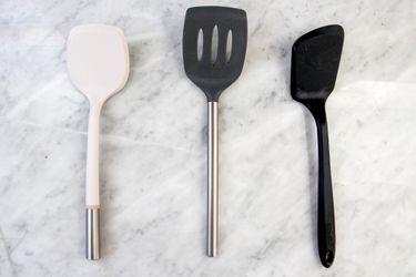 Three nonstick food turners on a marble counter