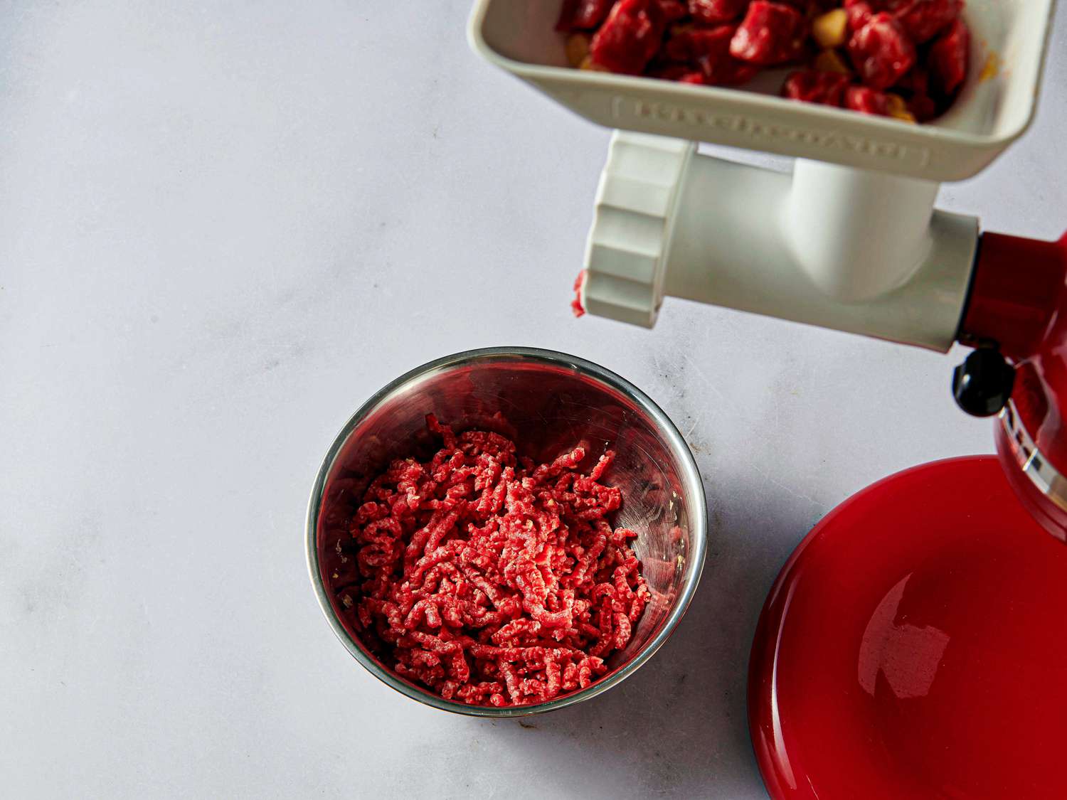 Overhead view of meet through meat grinder