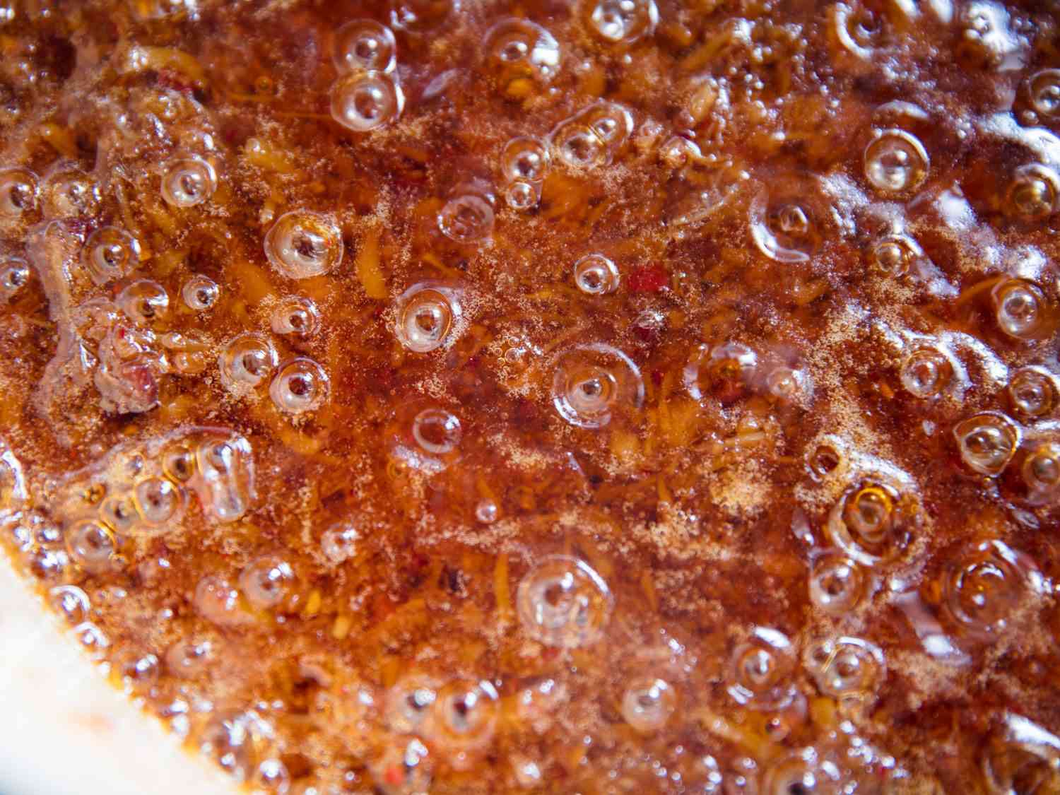 Bubbles of oil on the surface of a pot of XO.