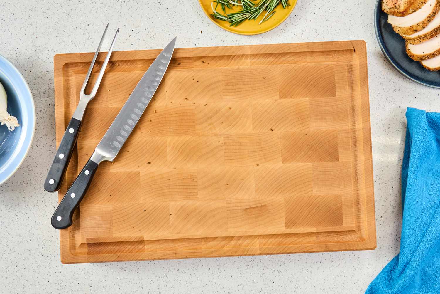 The Boardsmith Maple End-Grain Cutting Board with a knife and carving fork on it