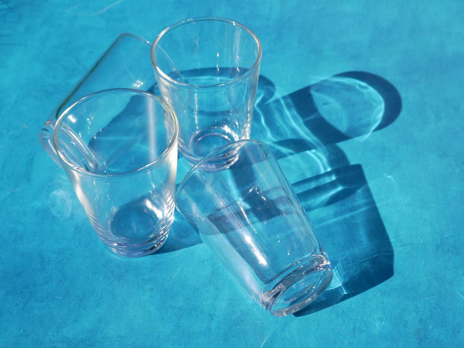 kinto hibi glasses on a blue surface 