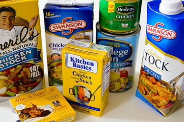 Containers of different store-bought chicken stocks.
