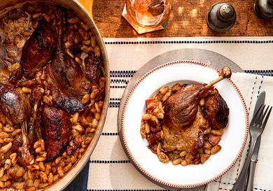 Overhead view of a single single serving of traditional French Cassoulet next to the pot.