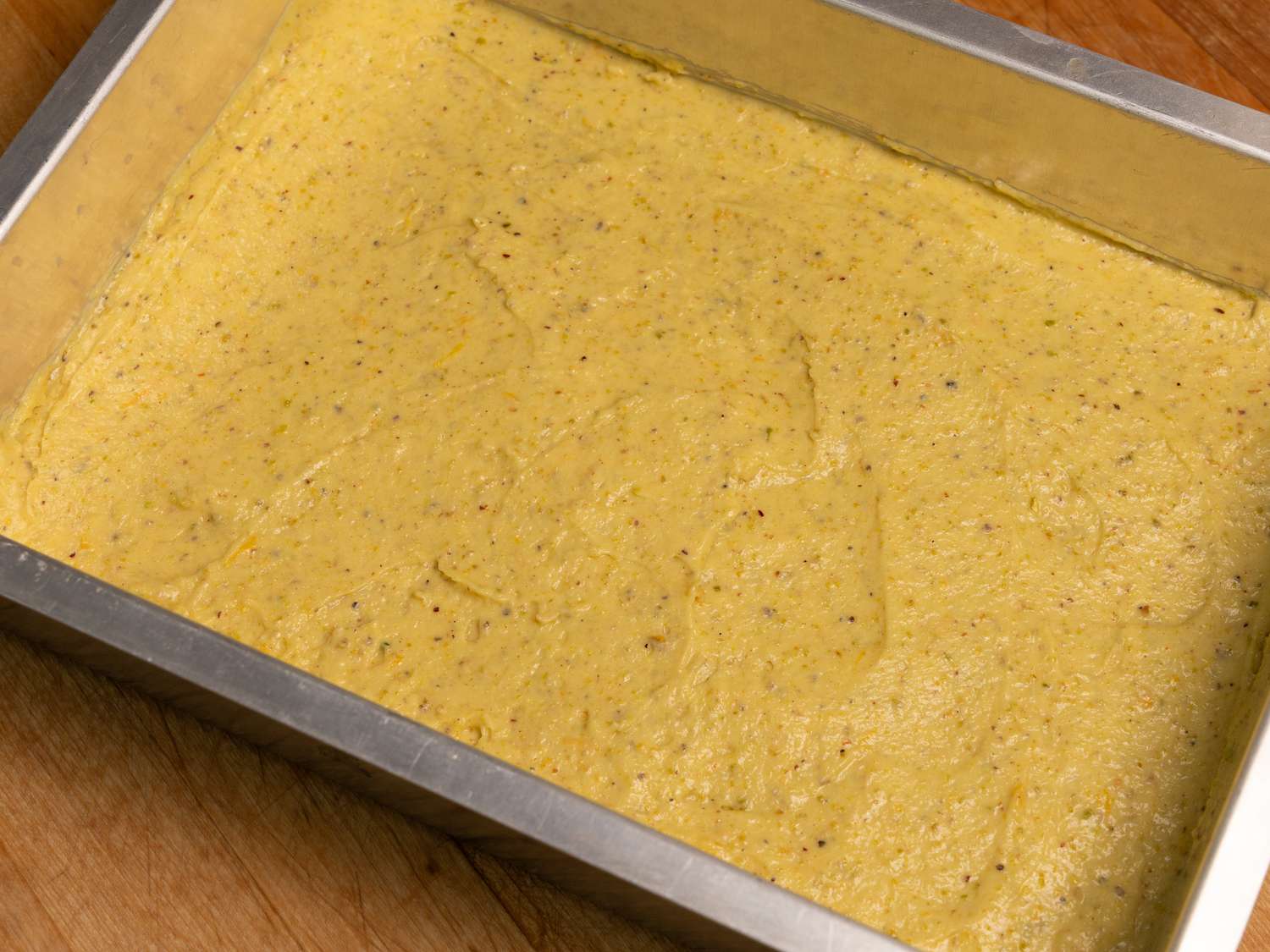 spreading dough into a baking pan