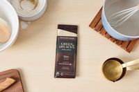 A partially unwrapped Green & Black chocolate bar.