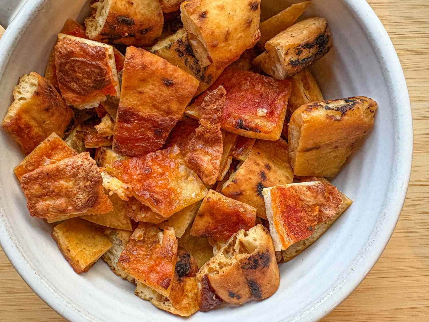 Bowl of baked crouton pieces from pizza dough