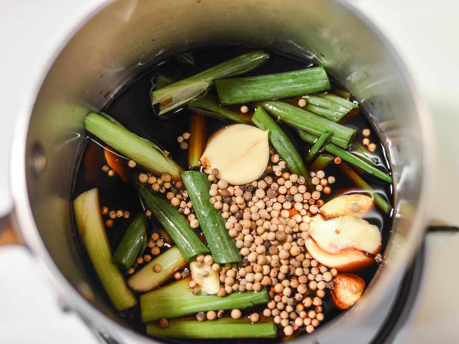 Overhead close-up of tare sauce ingredients in a saucepan, ready to simmer.
