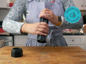 a person using the hexmill to grind pepper