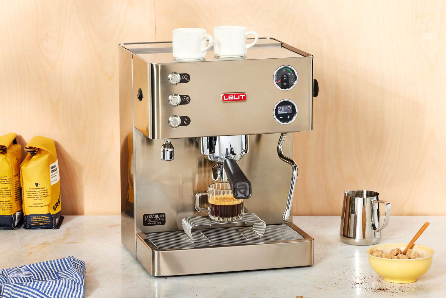 The Lelit Elizabeth Espresso Machine brewing an espresso into a glass cup on a white marble countertop