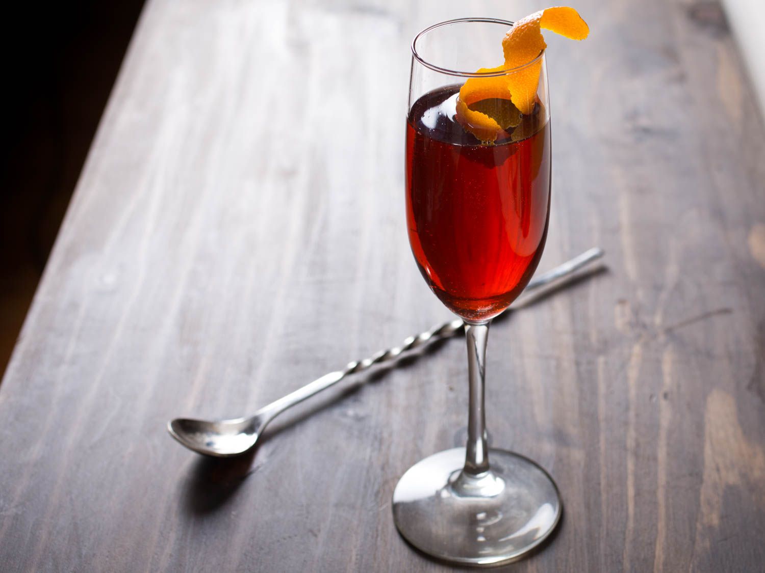 A negroni sbagliato served in a Champagne flute with an orange twist.