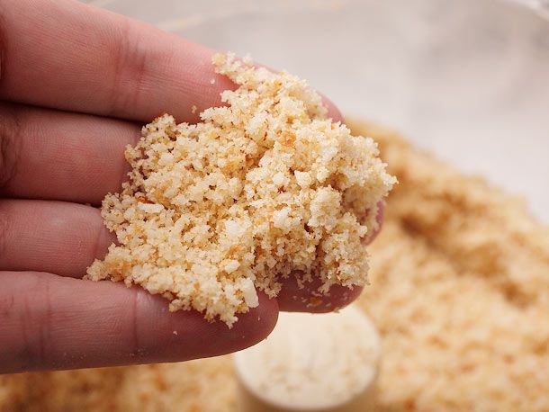 Author holding some of the processed bread crumbs to show their consistency.