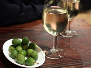 Green olives served with glasses of sherry
