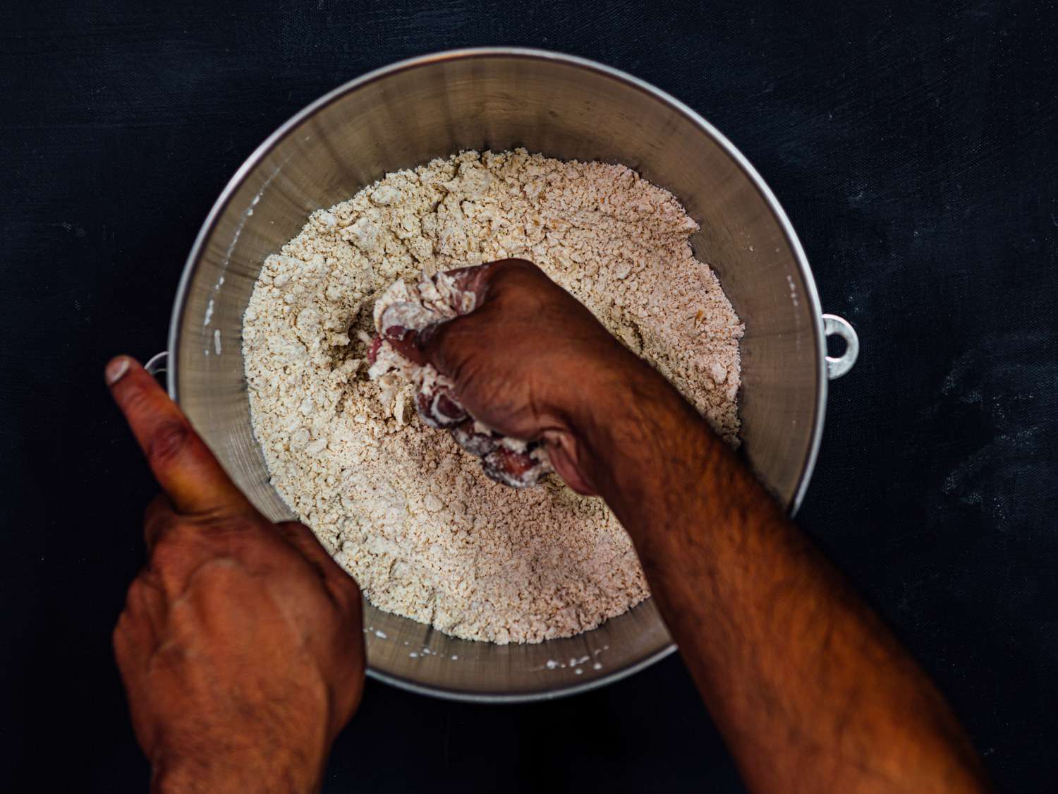 Oil is worked into the dry ingredients by hand.
