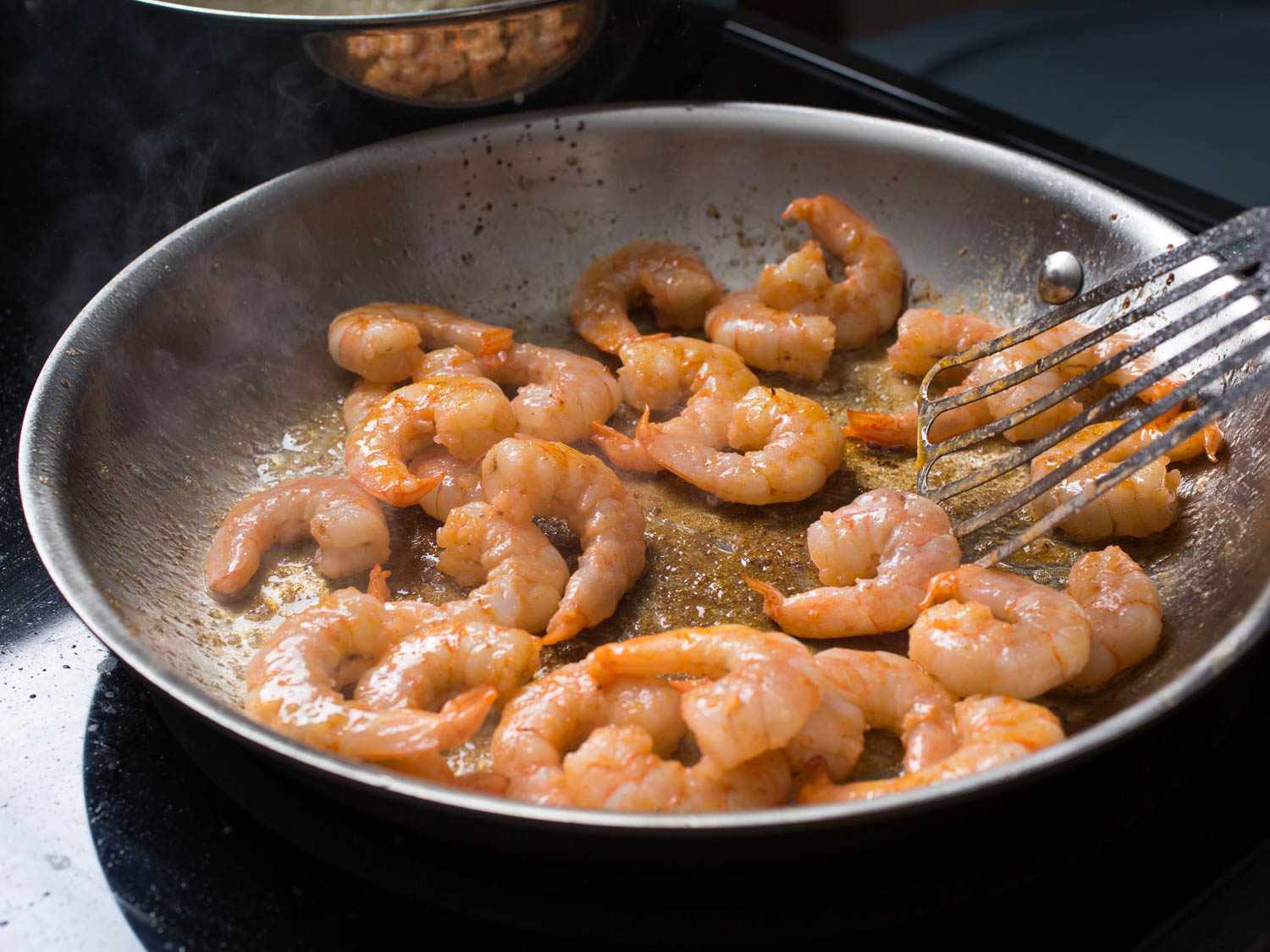 Sauteing shrimp in bacon fat.