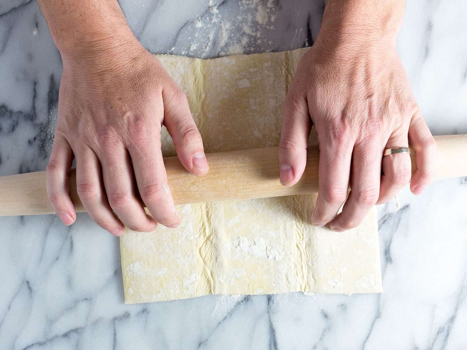 Rolling out puff pastry for baked brie.