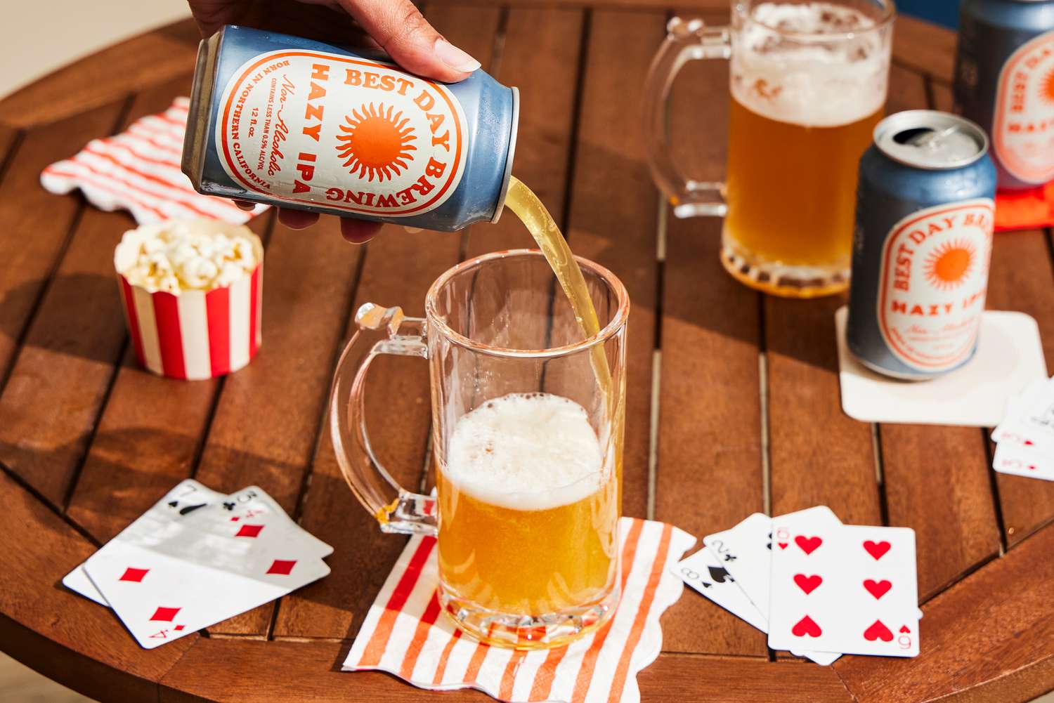 a hand pouring a can of best day hazy ipa into a glass