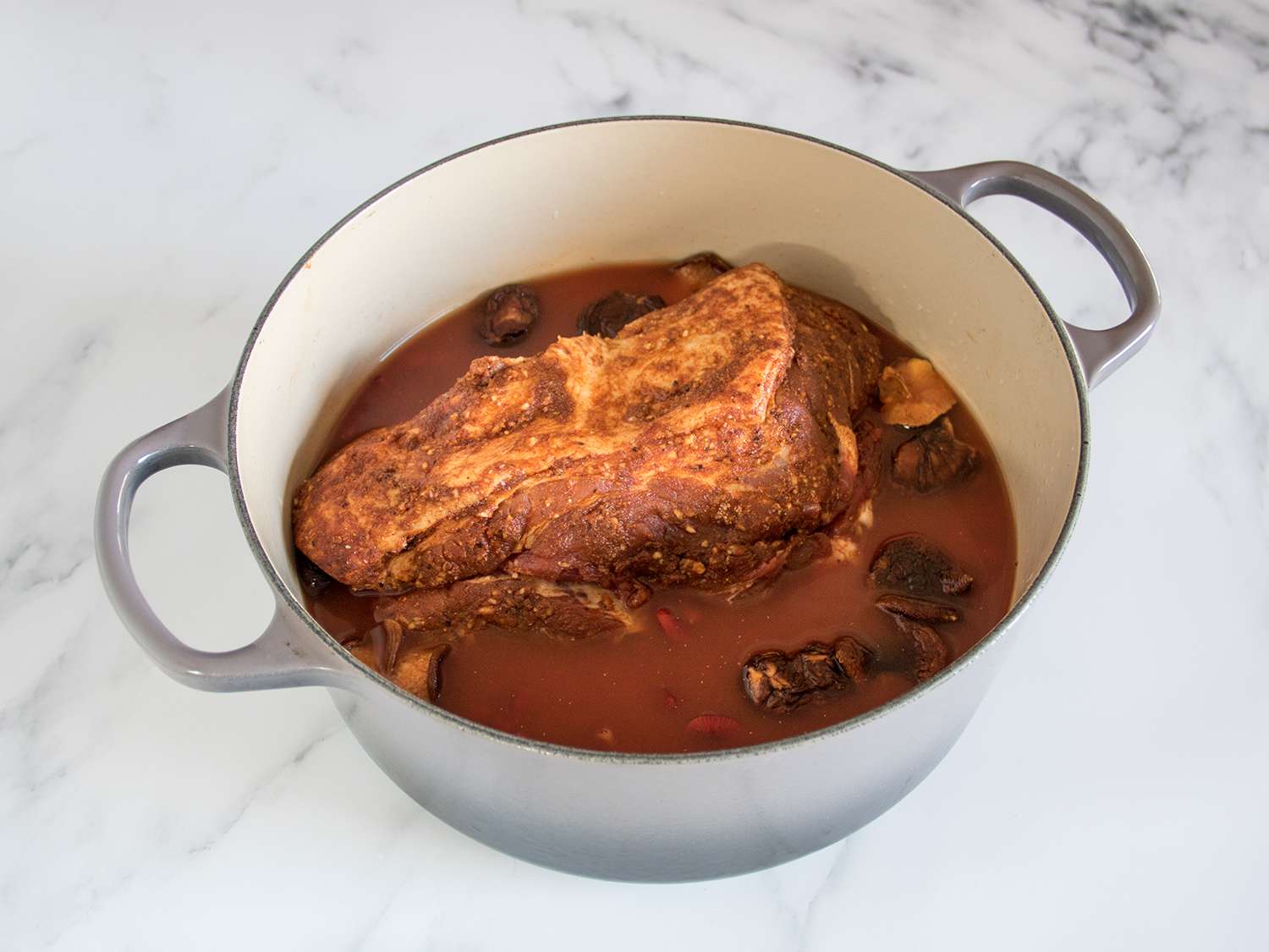 Seasoned pork in beans liquid.