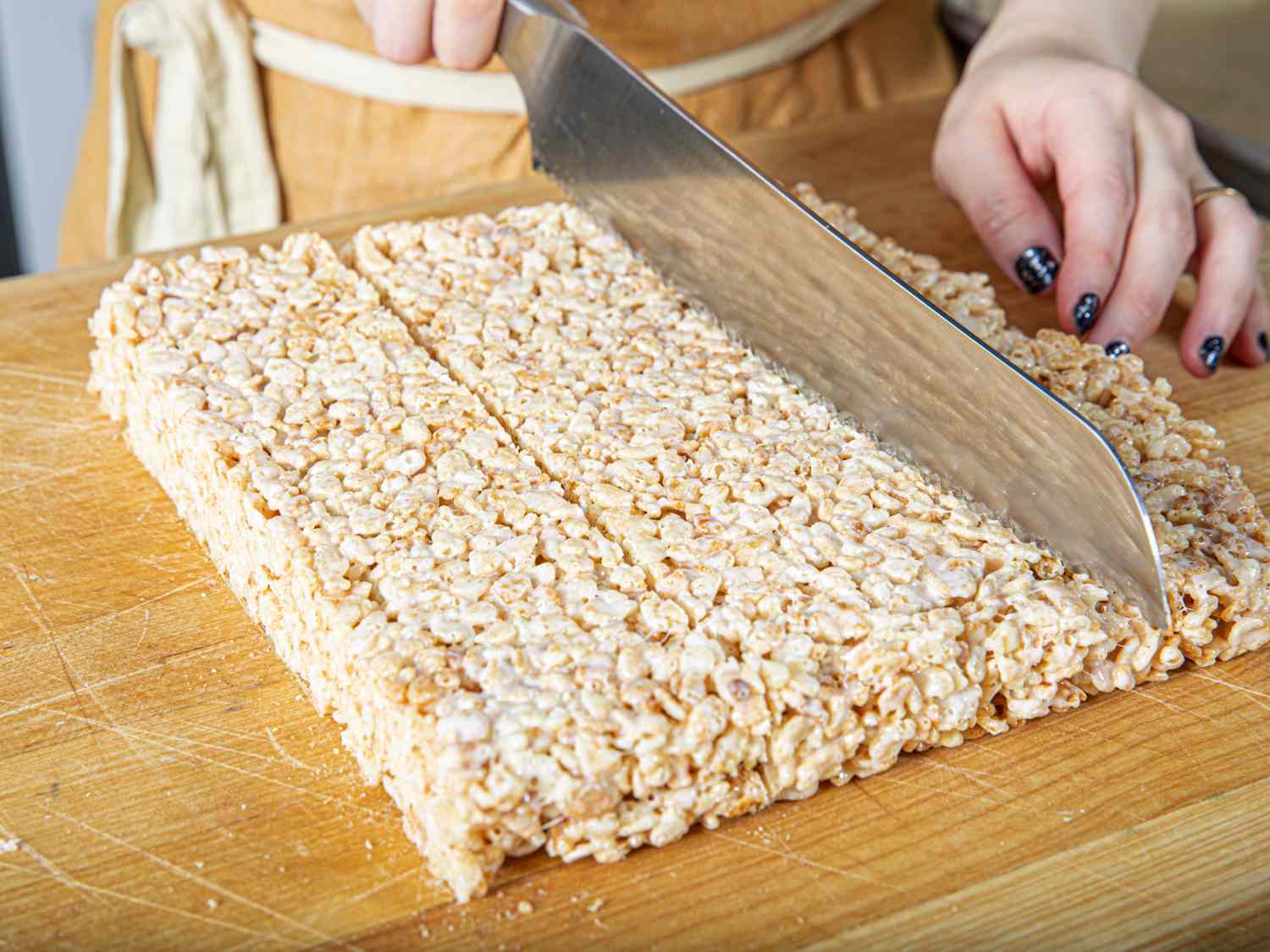Cutting rice krispies treats with a serrated knife 
