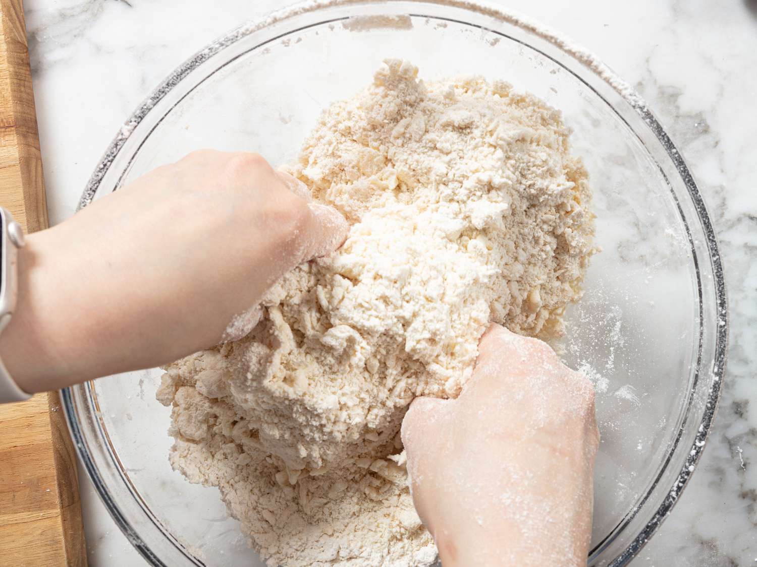 rubbing butter into dry ingredients in a large glass bowl 