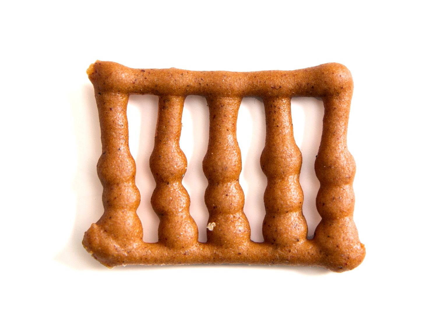 A railing for a gingerbread house, made from piped out gingerbread.