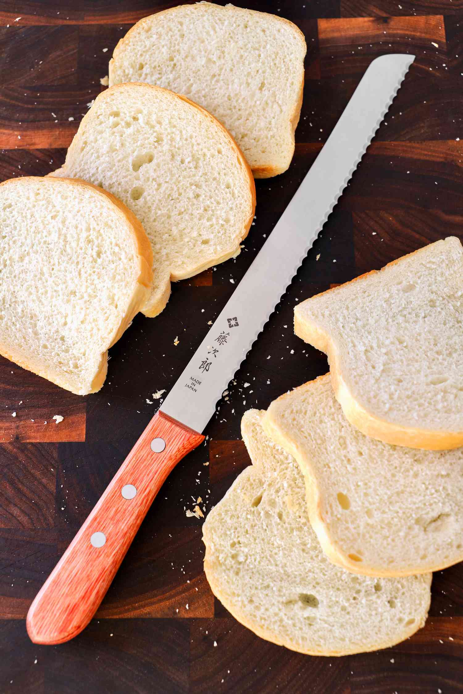 Tojiro F-737 Bread Slicer next to sliced bread