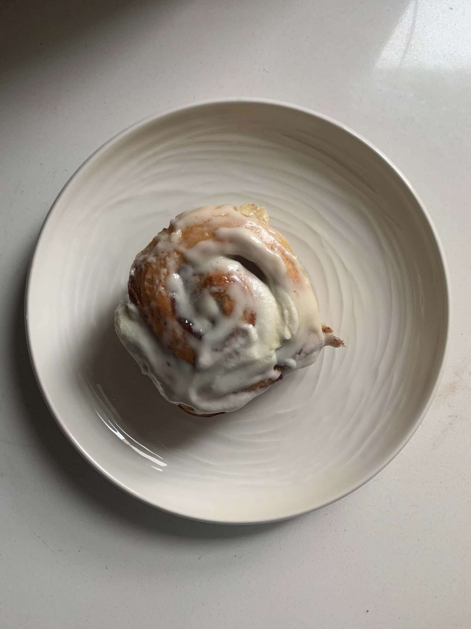 Glazed cinnamon bun on a plate