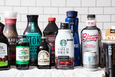A variety of bottled cold brew coffee products displayed on a surface, arranged in a neat layout
