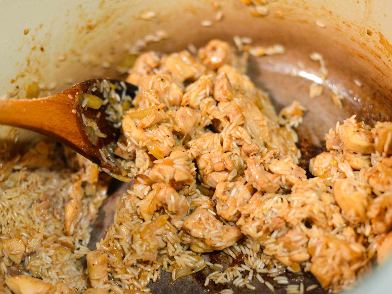 Rice is stirred into the chicken-onion mixture.
