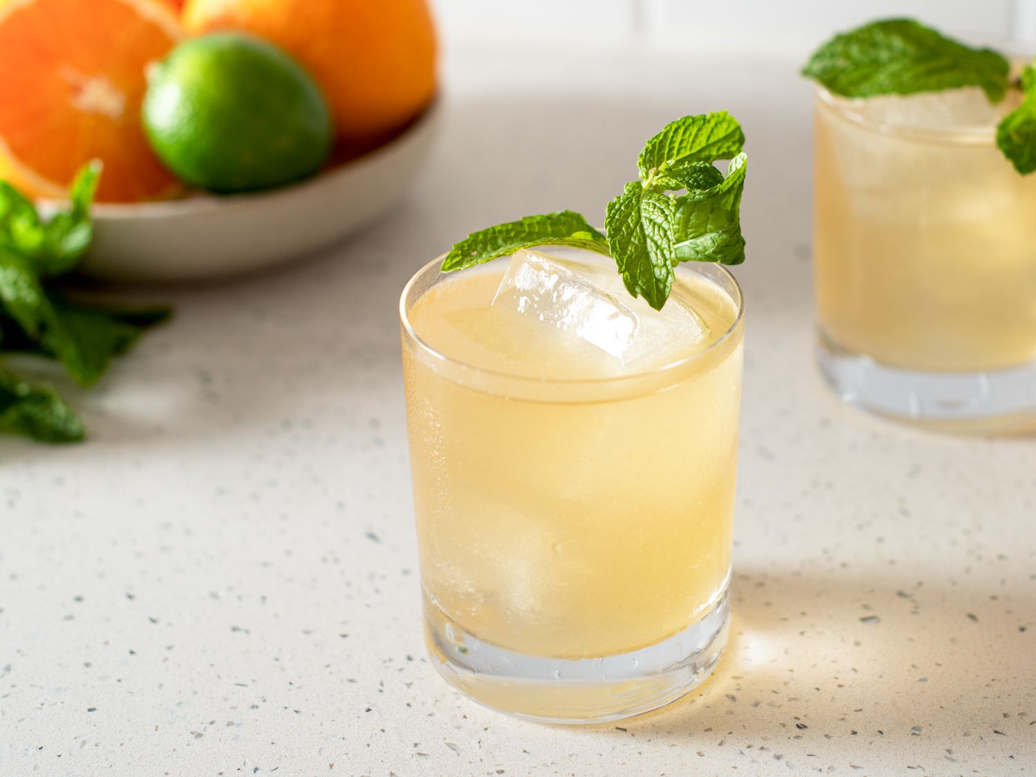 Suffering Bastard cocktail in a rocks glass garnished with mint leaves