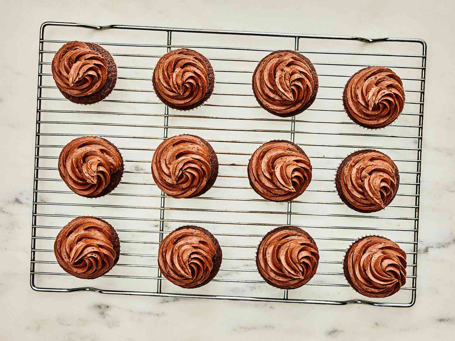 Cupcakes on cooling rack with piped buttercream 