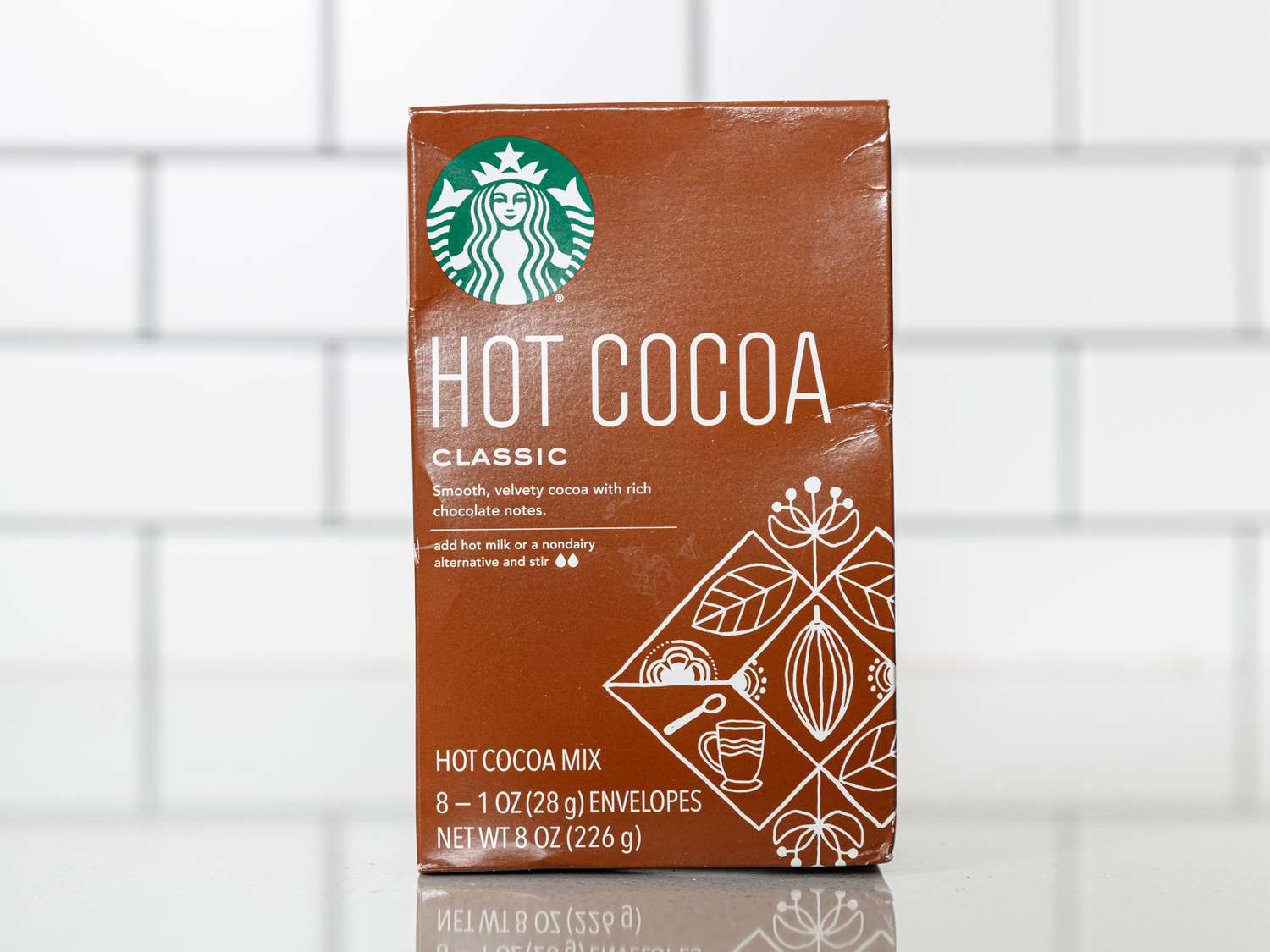 Starbucks brand box of Hot cocoa on white surface with white tile background