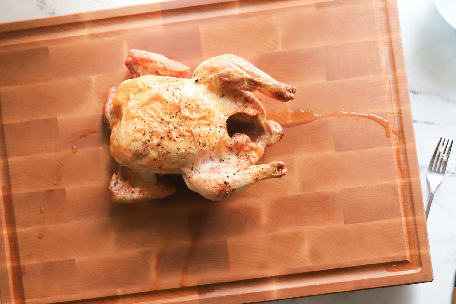 A roasted chicken on a carving board