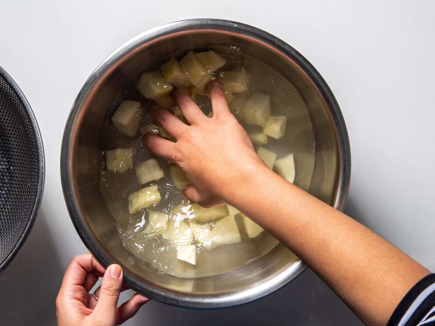 swishing potatoes in water