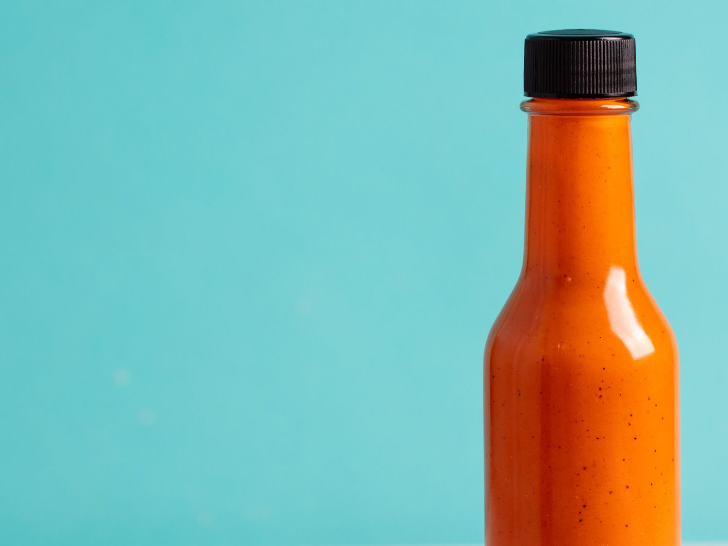 A bottle of bright orange charred fresno and tamari fermented hot sauce.