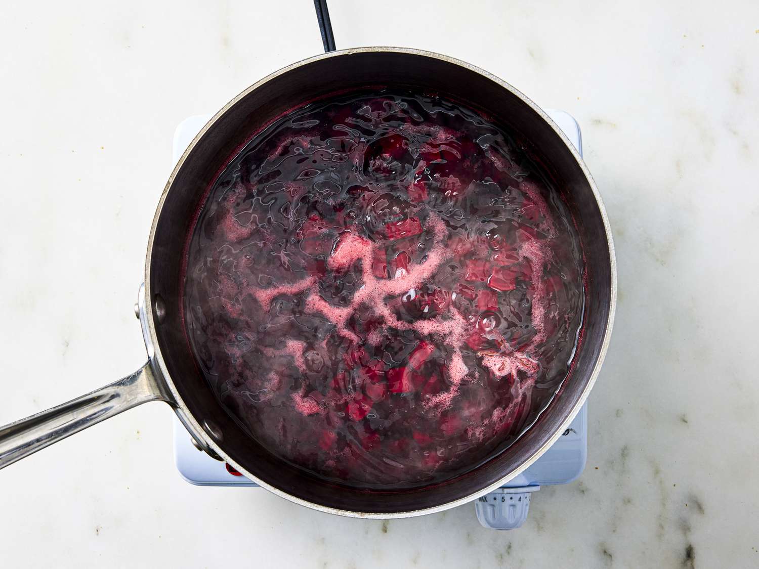 Beets and cherries in a pan on the stovetop