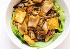 Overhead view of braised mushrooms, tofu, and Chinese mustard greens 