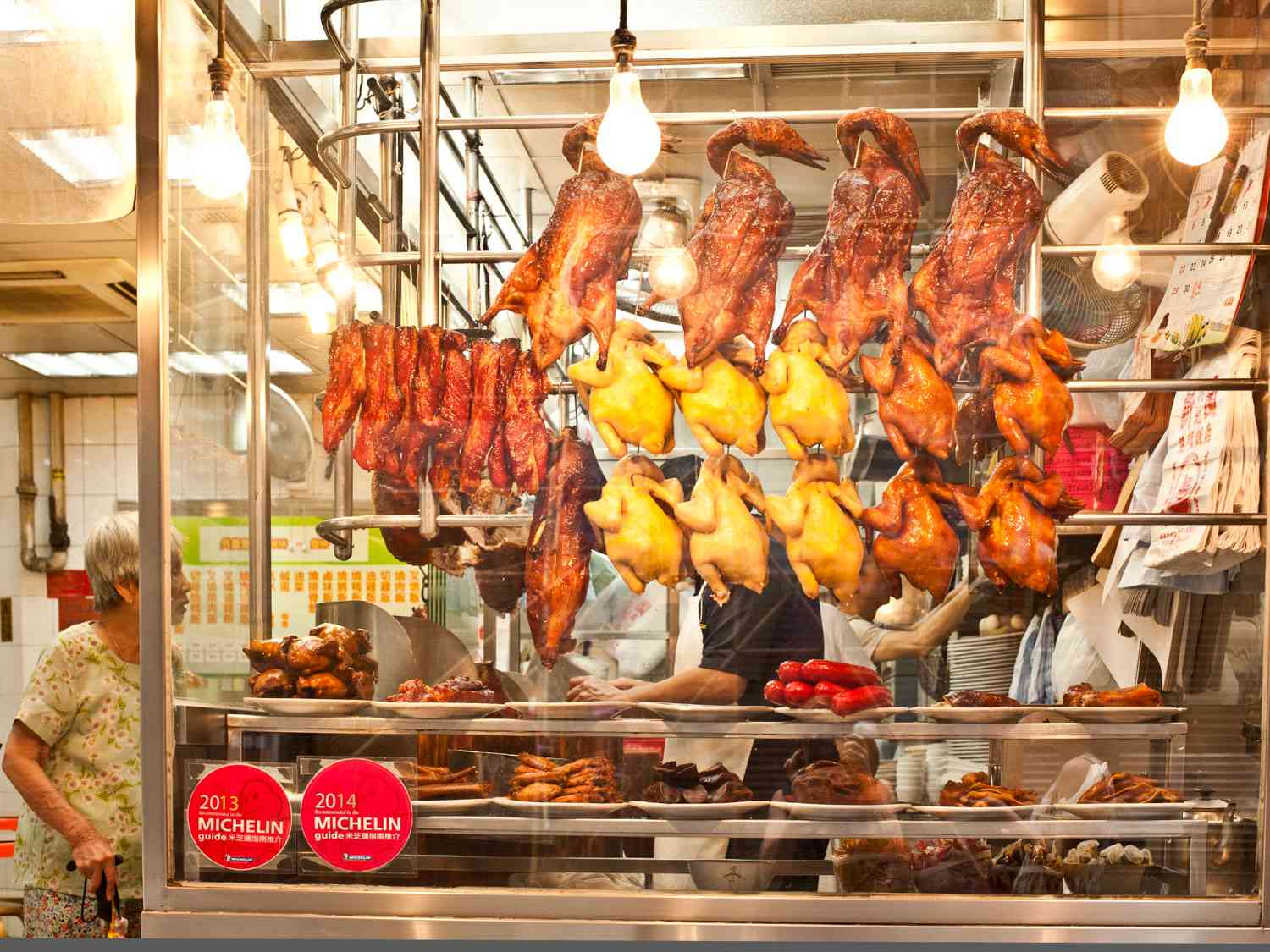 Siumei handing in the window of a market 