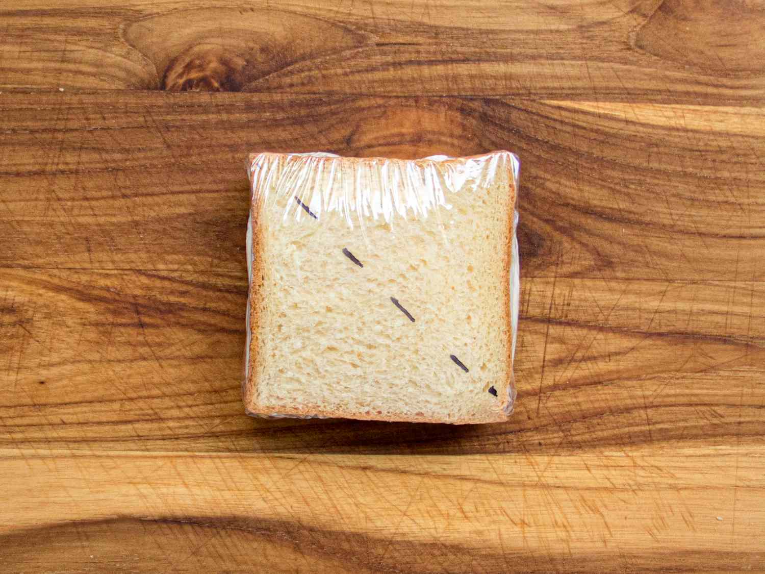 Overhead view of wrapped sandwich with cut marks