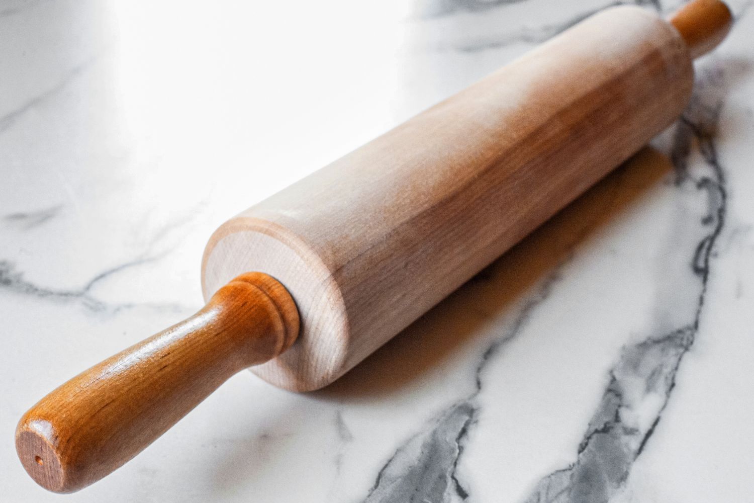 A J.K. Adams Maple Wood Medium Gourmet Rolling Pin on a marble surface