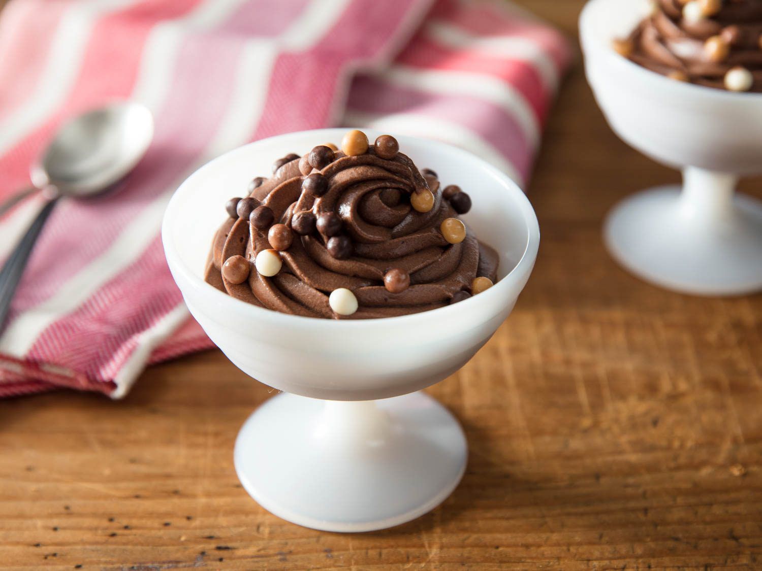 A white dessert bowl filled with eggless chocolate mousse.