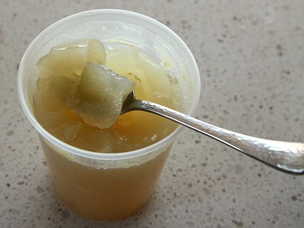 Broth made with pork trotters naturally thickened with gelatin in a deli container. 