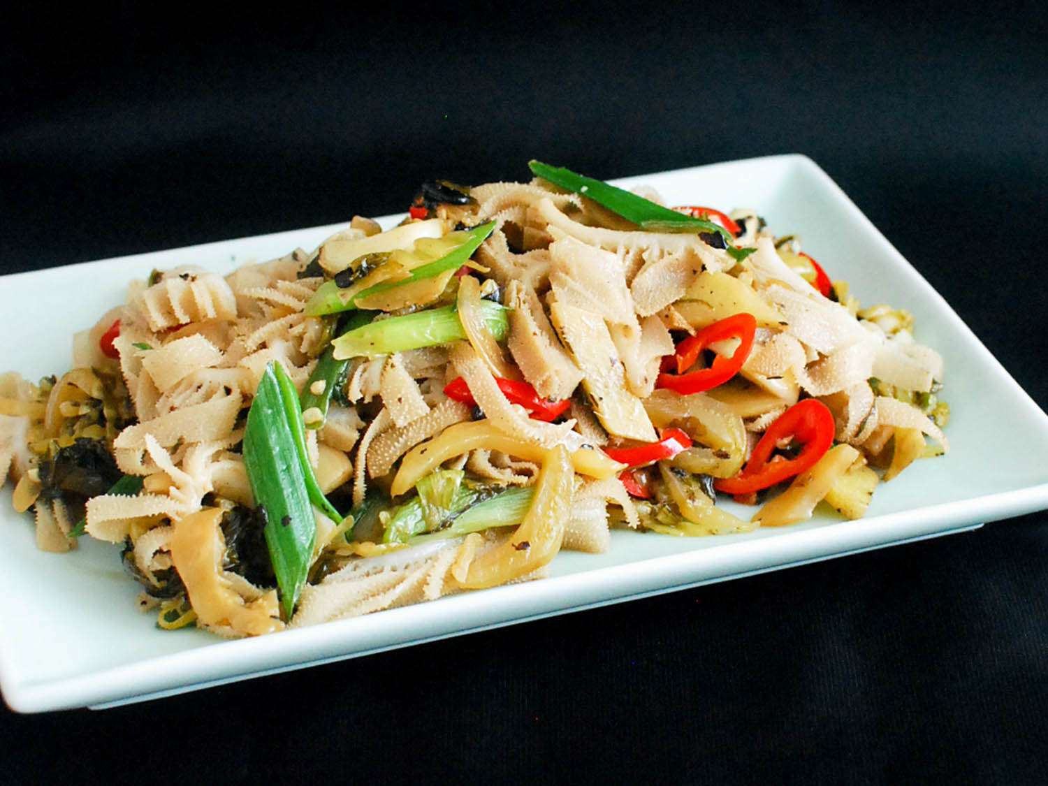 Stir Fried tripe with pickled mustard greens and fermented black beans on a platter. 